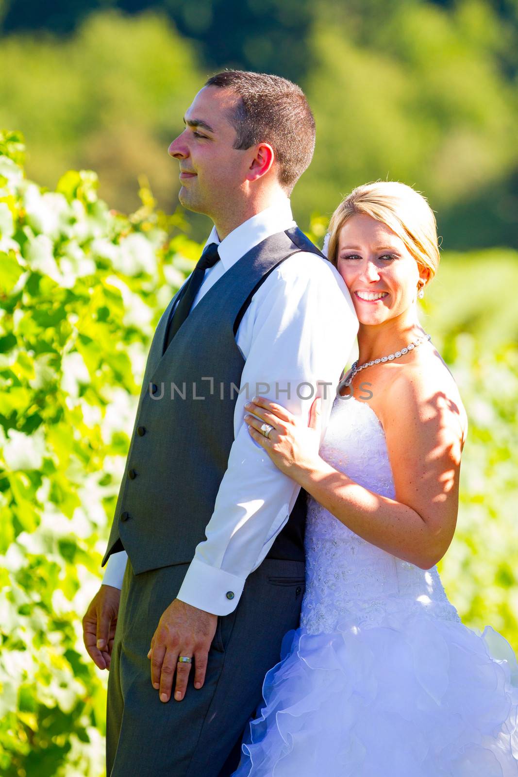 Portraits of a bride and groom outdoors in a vineyard at a winery in Oregon right after their ceremony and vows.