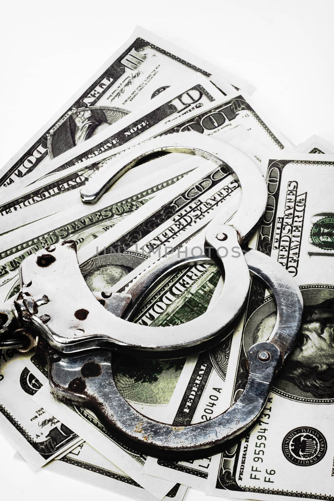 handcuffs and dollar bills close up