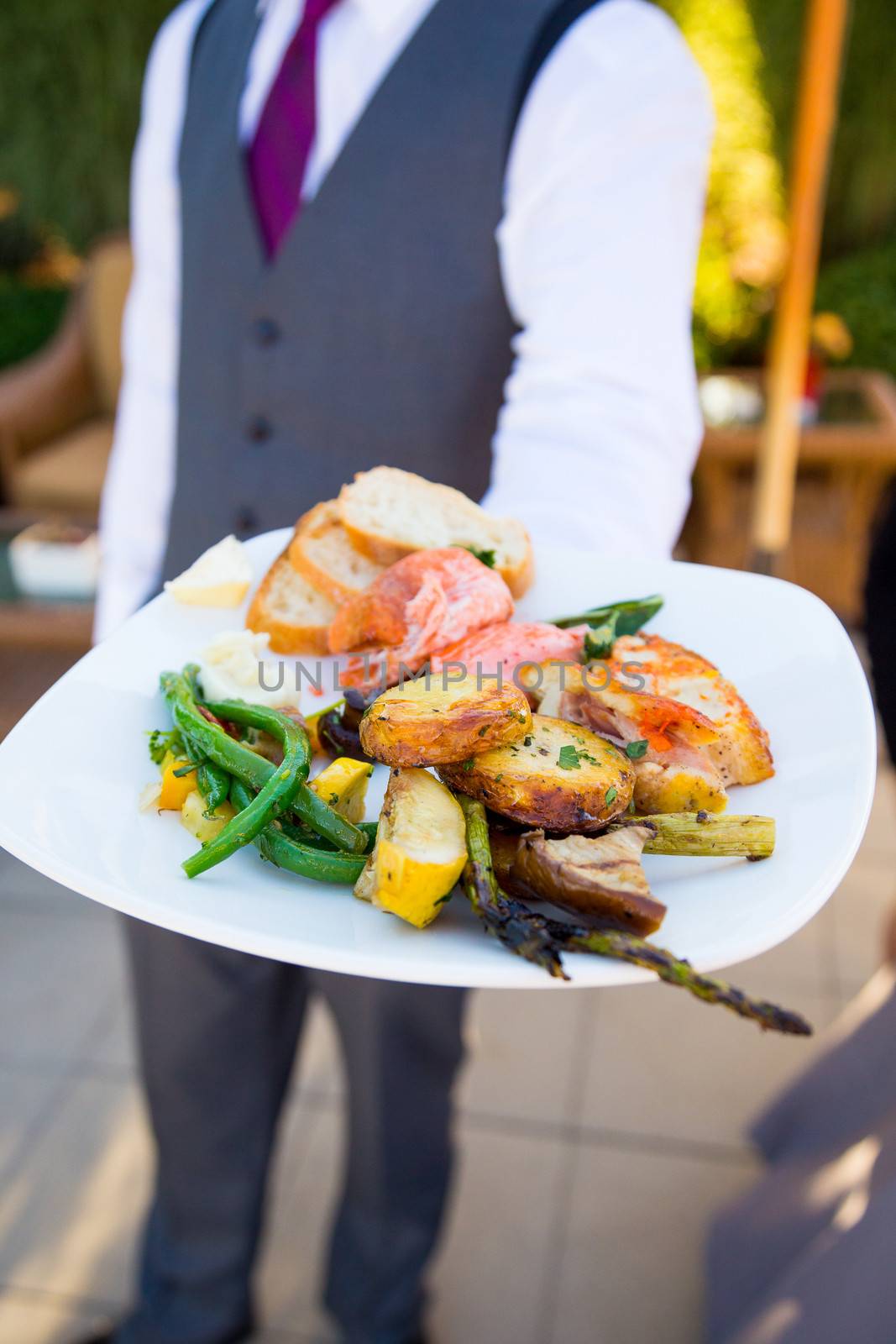 Dinner is served at this beautiful wedding reception outdoors at a vineyard.