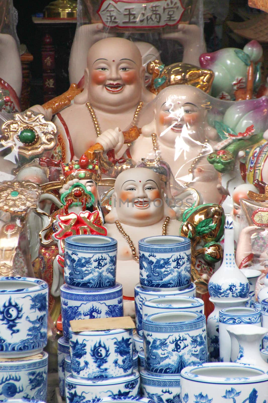 Market stall with colorful ceramic vases and Buddha figurines in Hanoi