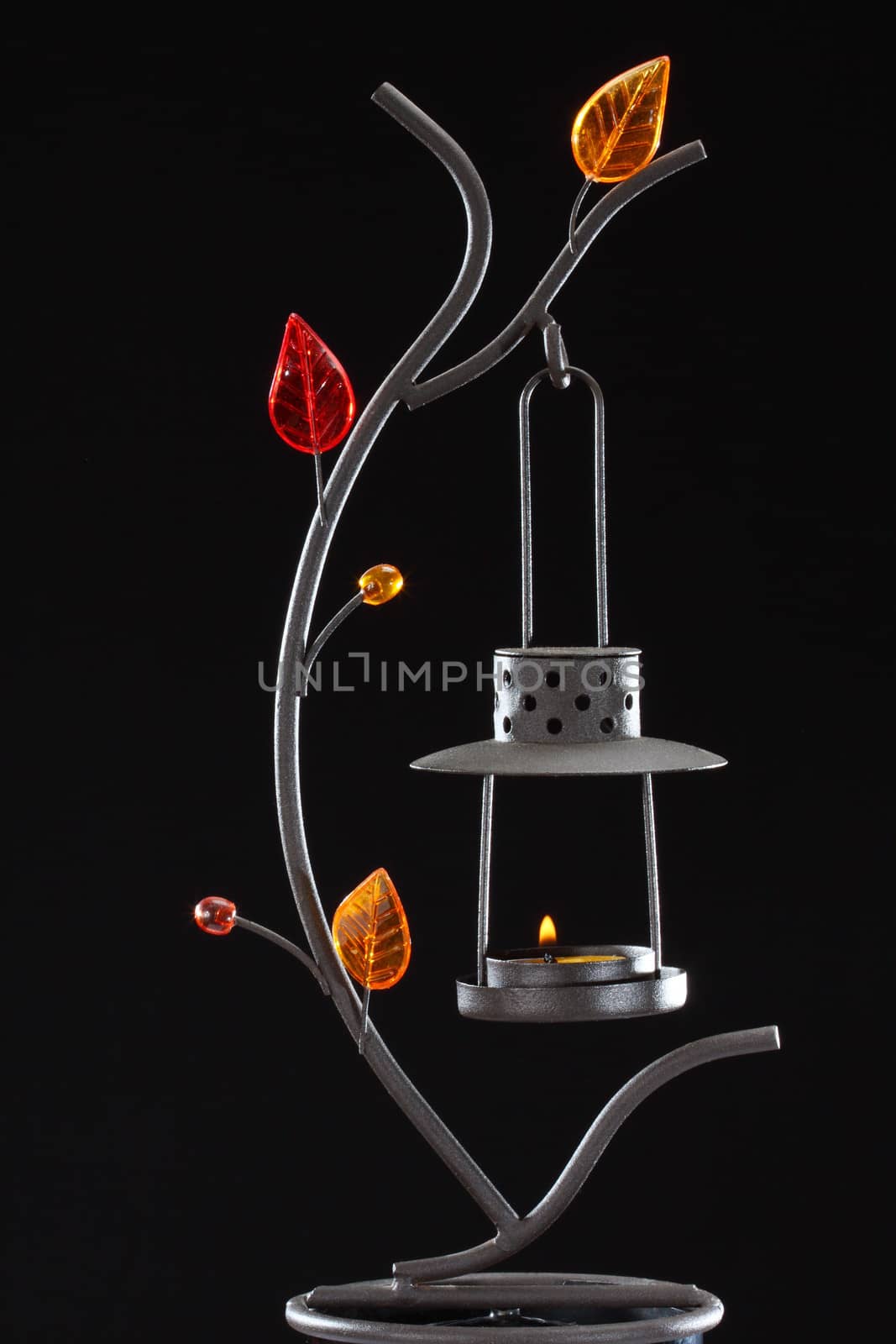 candle holder with glass decorations over black