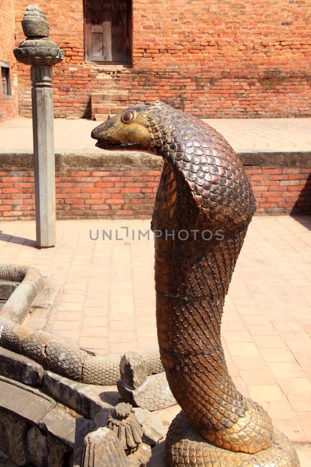 Statue of Bronze cobra in Bhaktapur, Nepal  by nuchylee