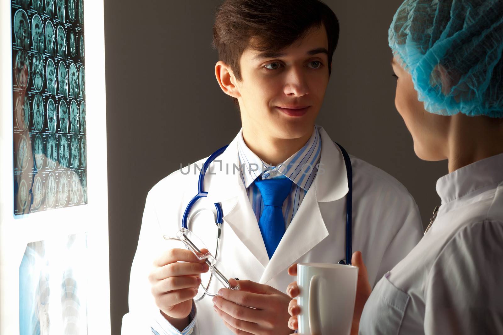 Two doctors examining x-ray results by sergey_nivens