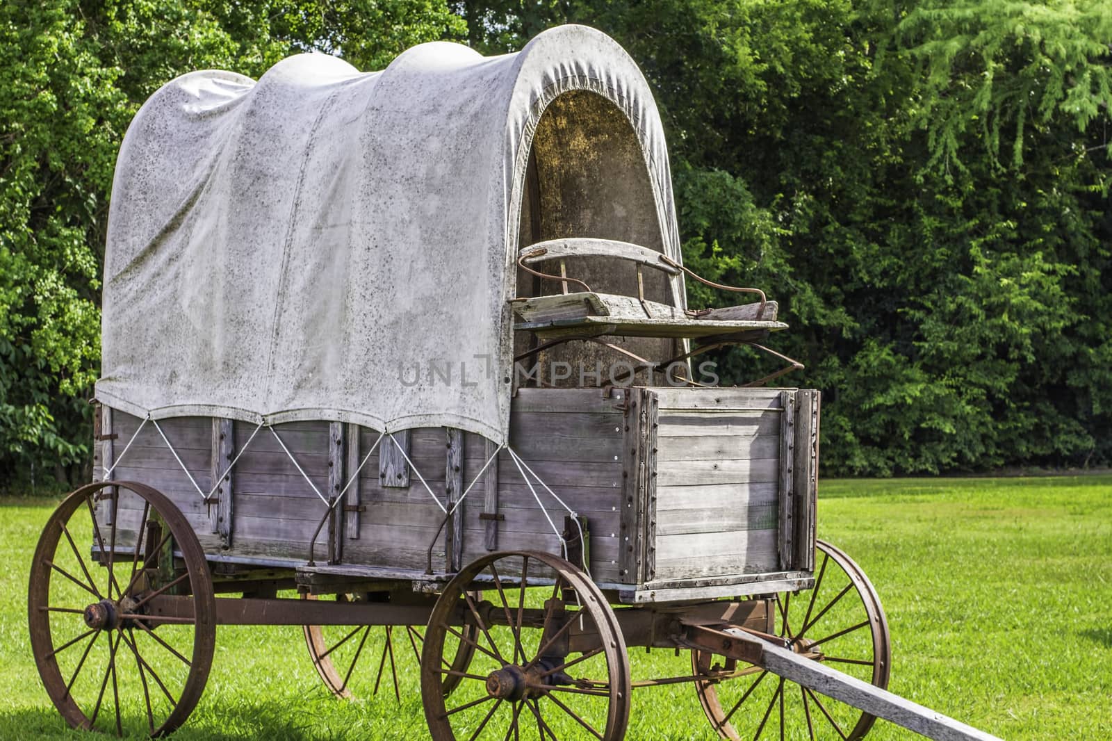 A side view of a stagecoach that was from the 1800s.