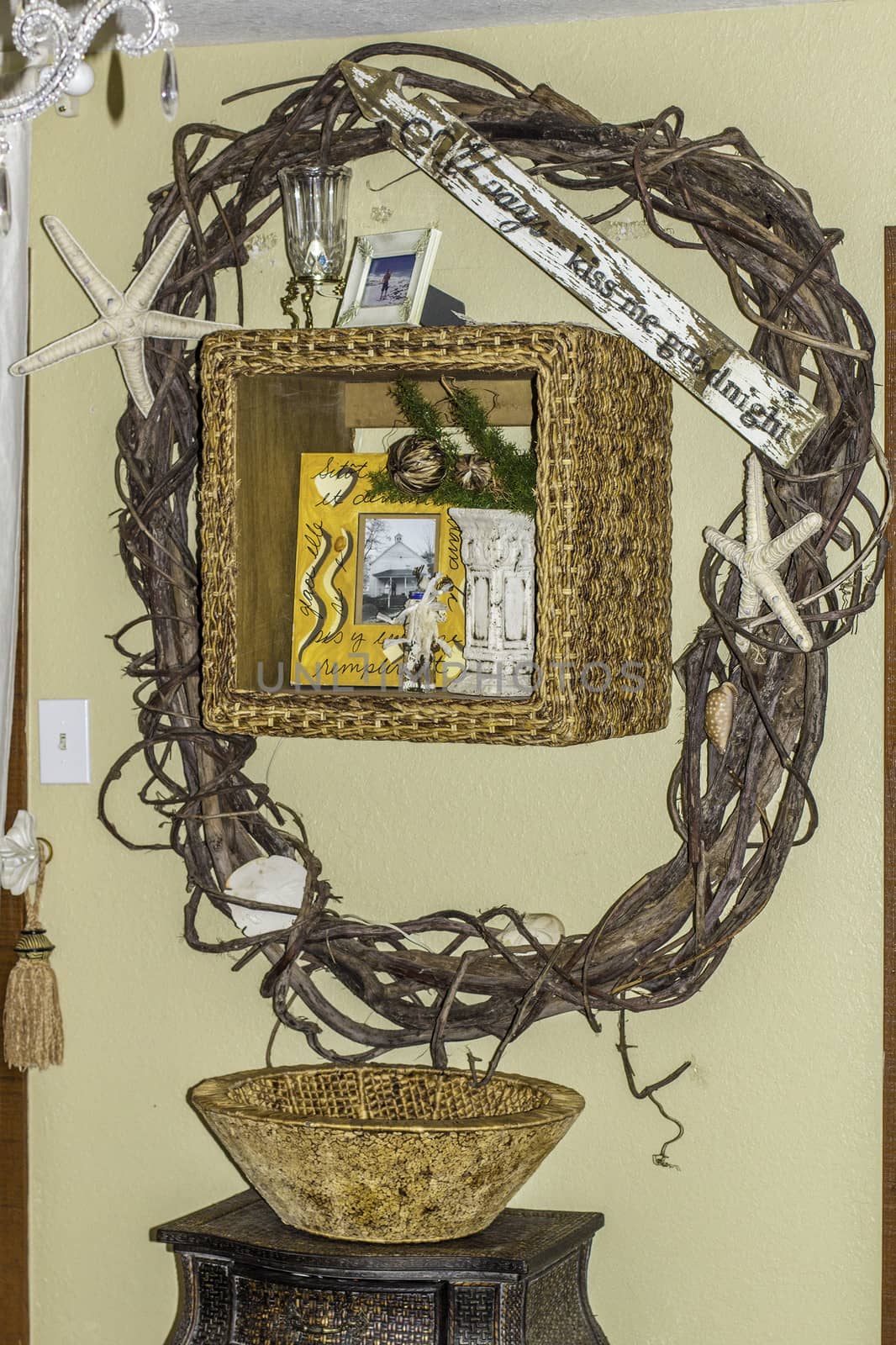 A view of a decorative wicker wreath hanging on a wall.