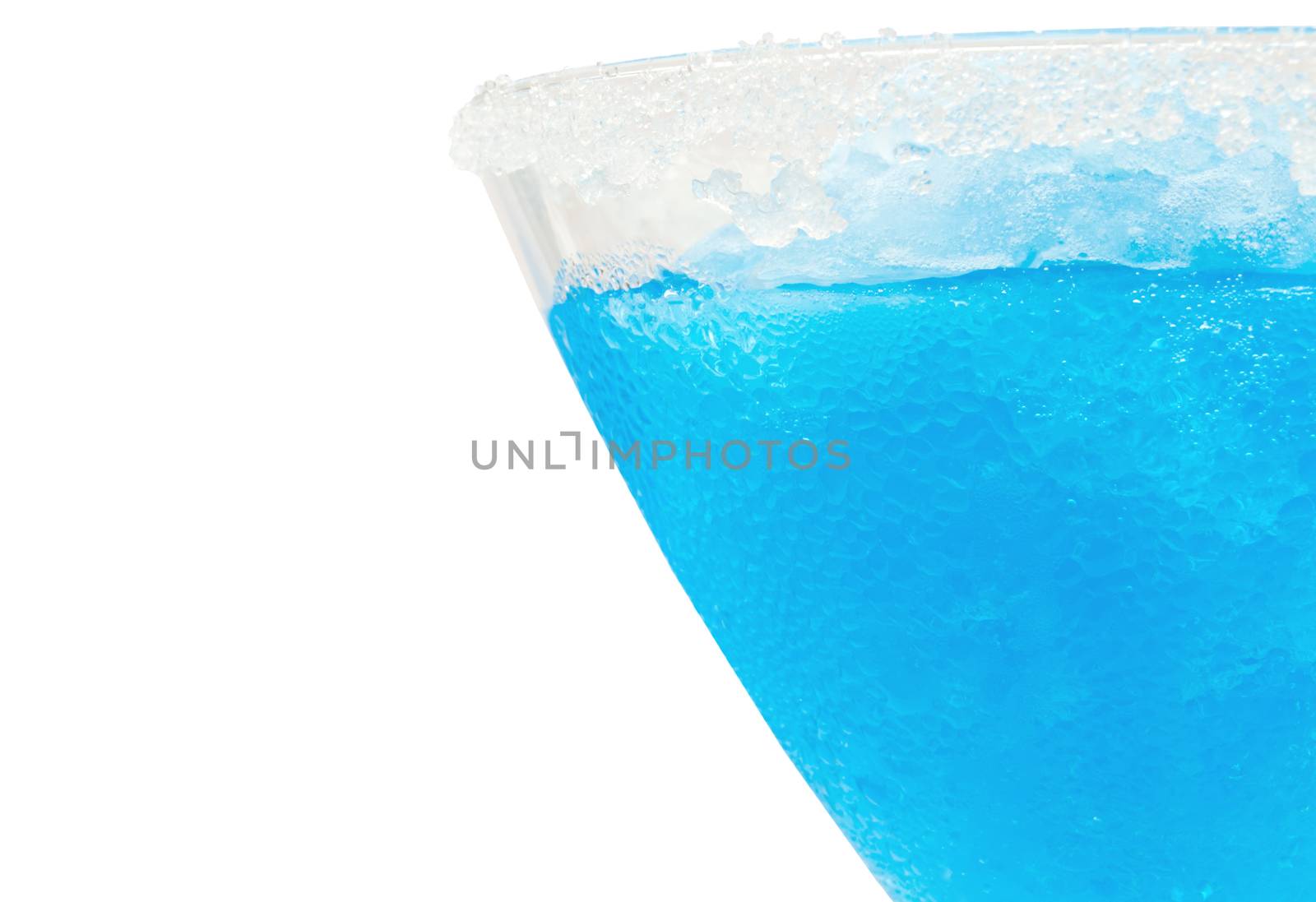 Closeup of a chilled blue cocktail over a white background 