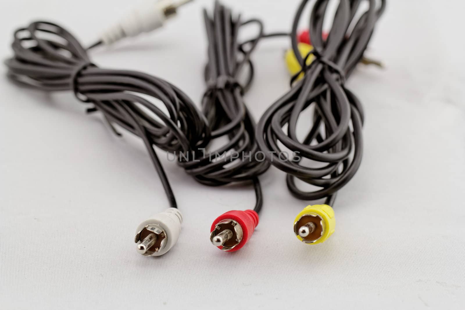 three audio (left - right) - video RCA cable and plug (red, white, yellow) on white background