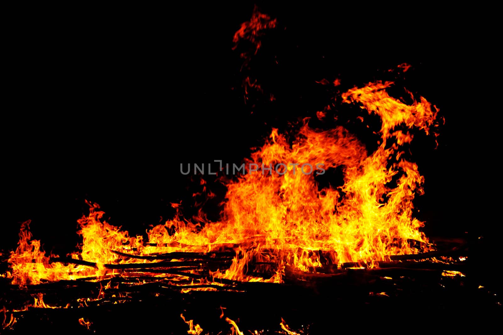 red flames of huge bonfire or campfire as black backgorund