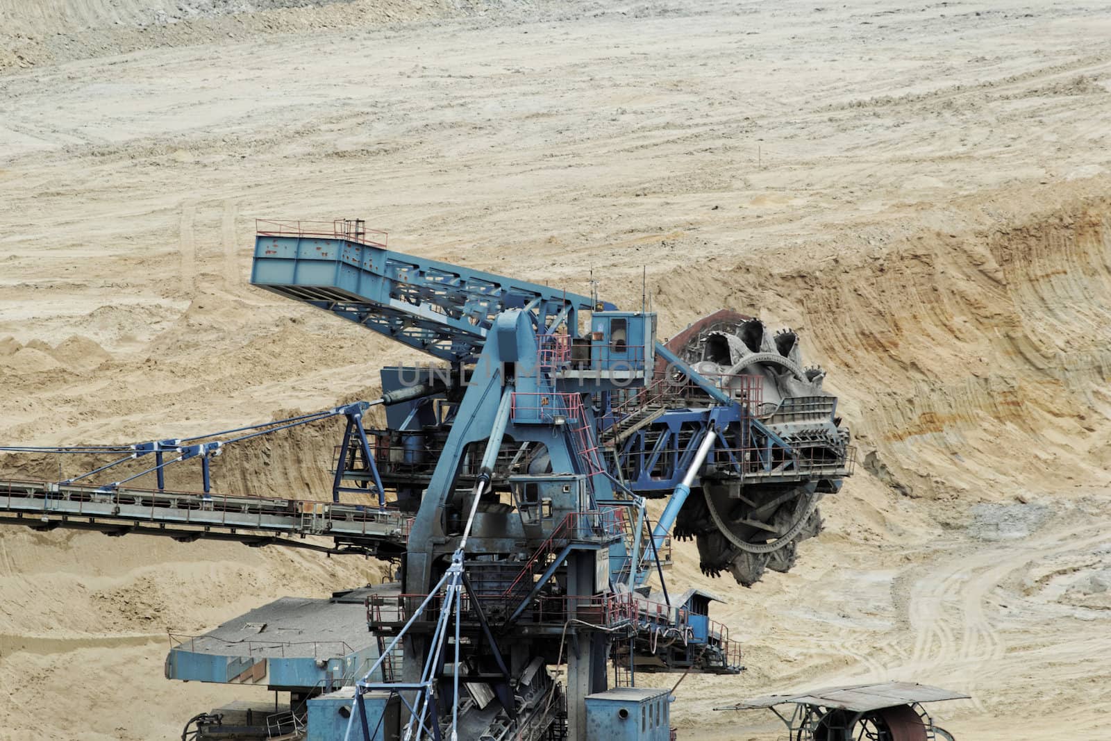 Coal mining in an open pit with huge industrial machine