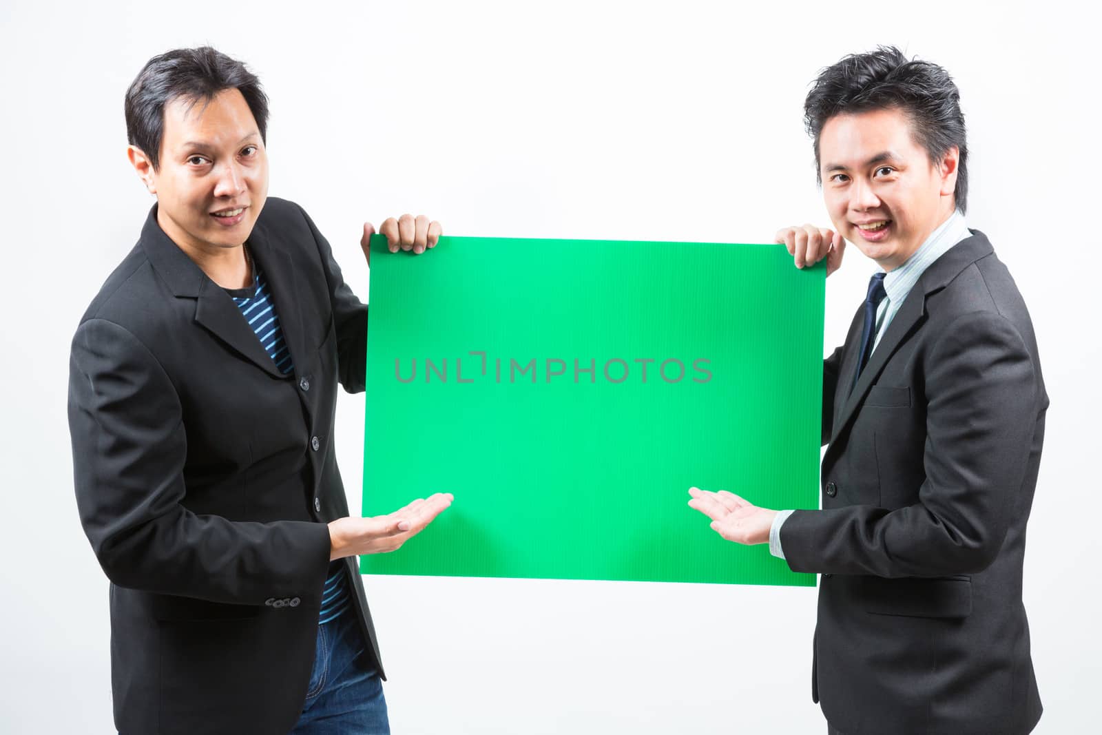 Businessmen holding a blank green banner