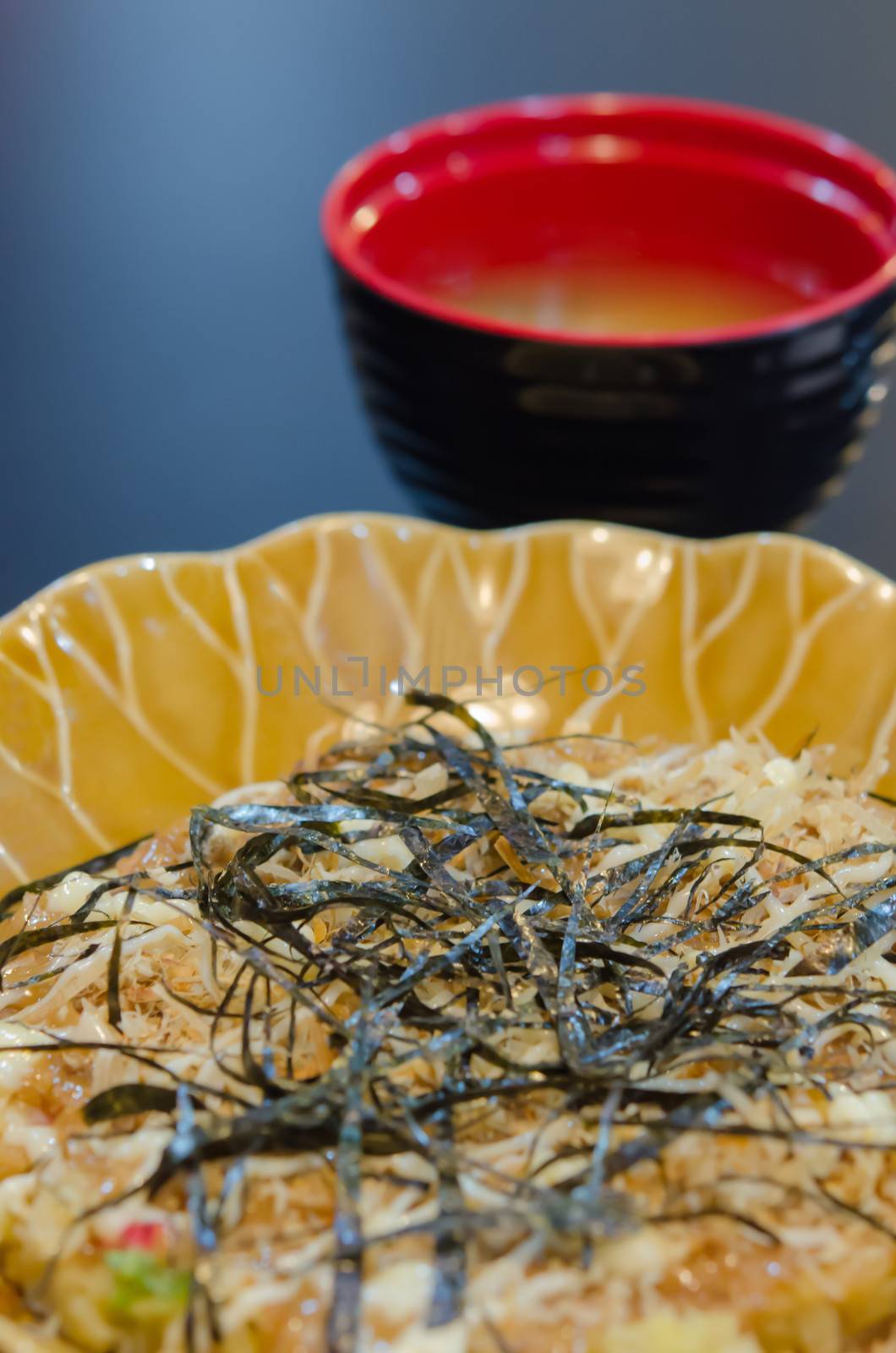 close up pizza Japanese style food , ( Okonomiyaki ) with soup