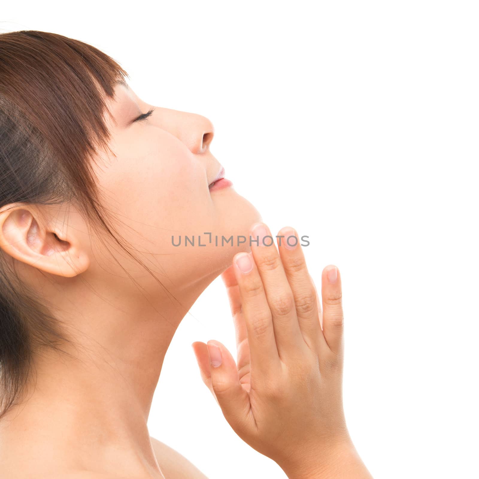 Asian skincare woman pampering face skin, skin care refreshing concept. Side view facial close up of beautiful mixed race Asian. Girl isolated on white background