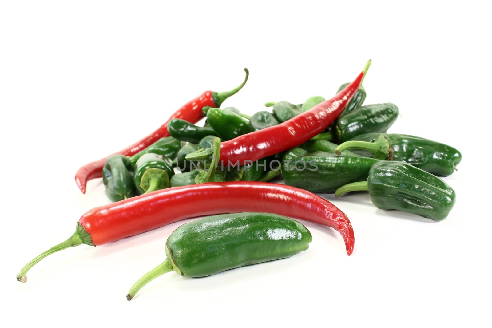 green Pimientos with hot peppers on a light background