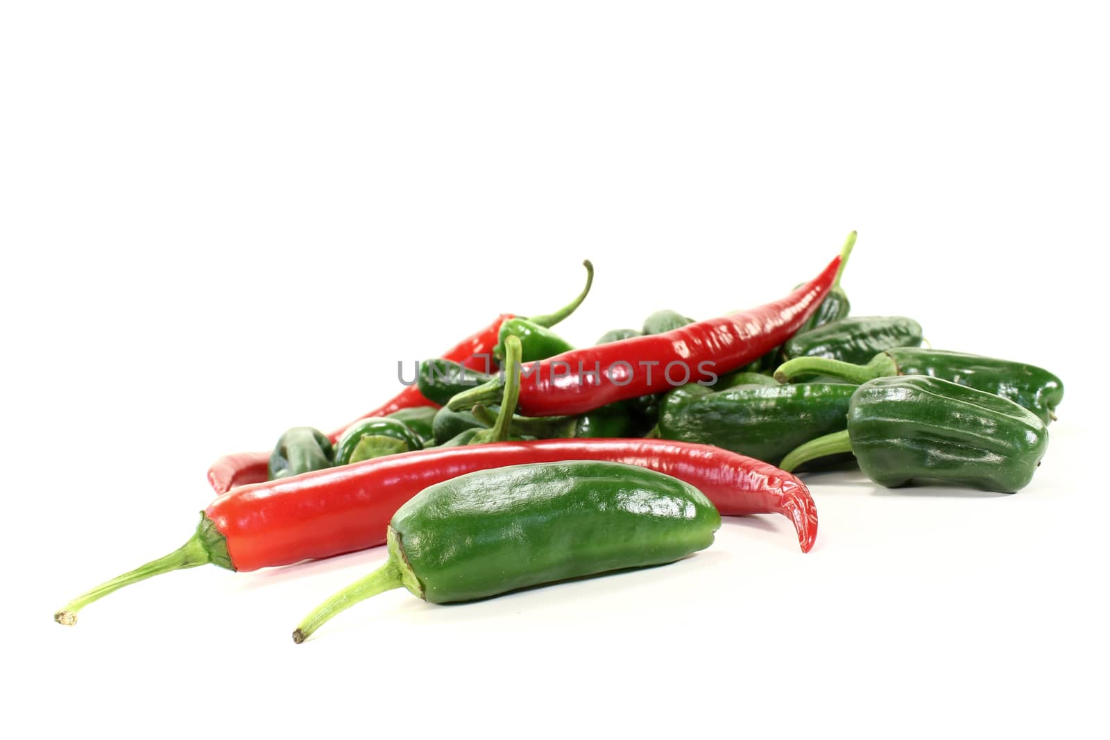 green Pimientos with red hot peppers on a light background