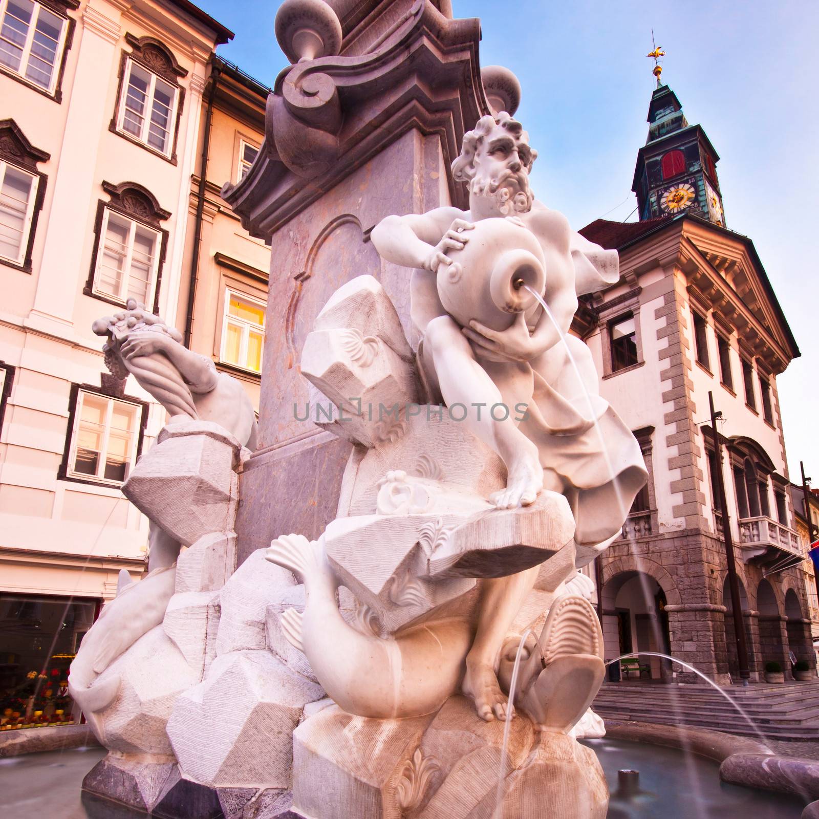 Evening view of Ljubljana's historic city center, Roba's fountain and the town hall in the background.