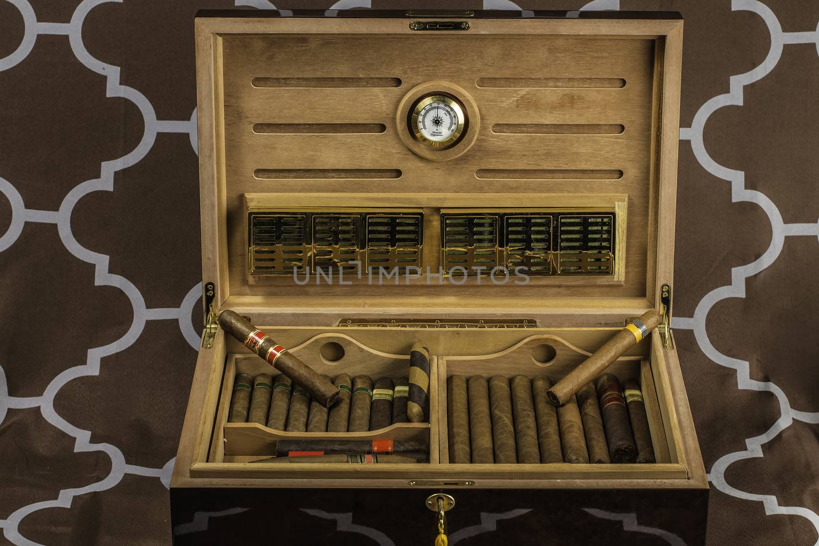A large cigar humidor showing off a selection of smokes with the lid open.