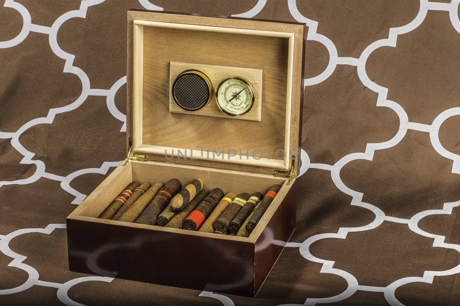 A cigar humidor showing off a selection of smokes with the lid open.