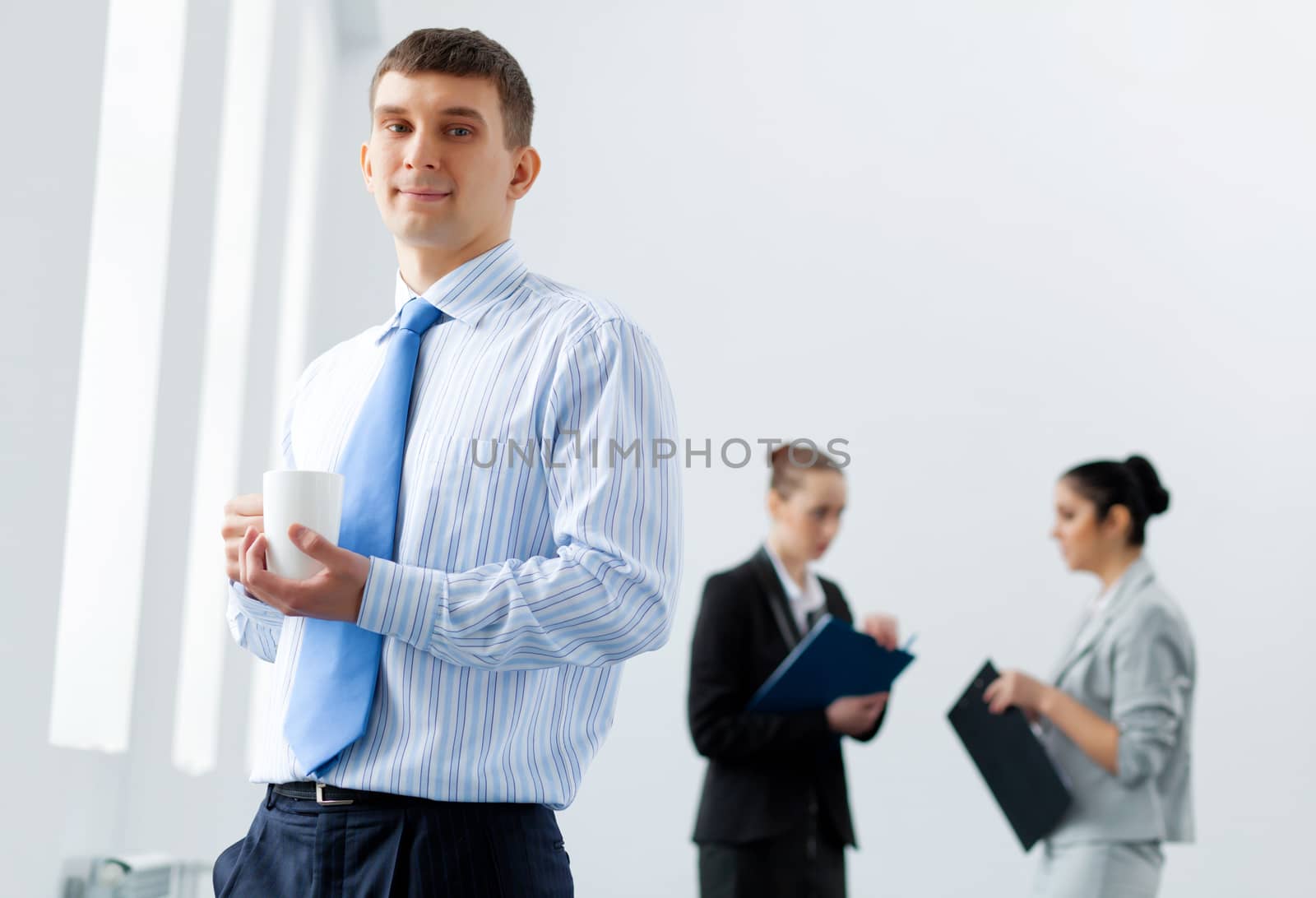 Image of three young businesspeople laughing joyfully