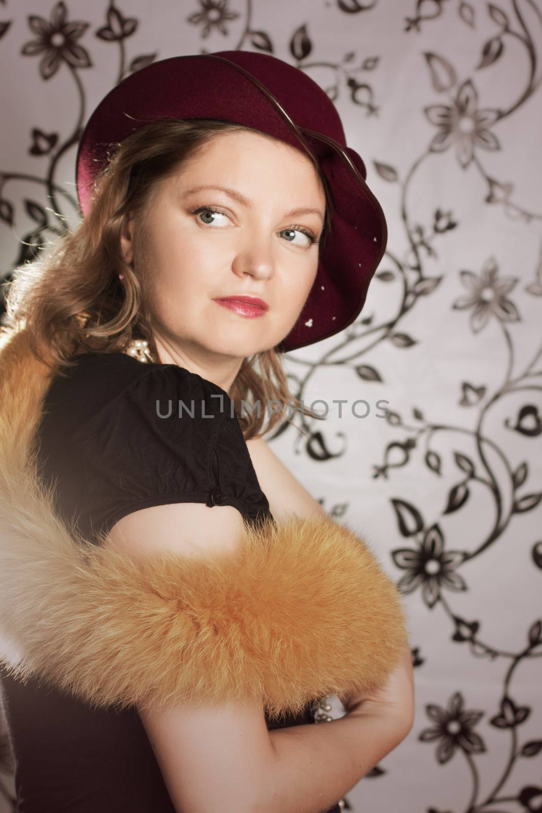Retro woman in hat and boa over glamorous background
