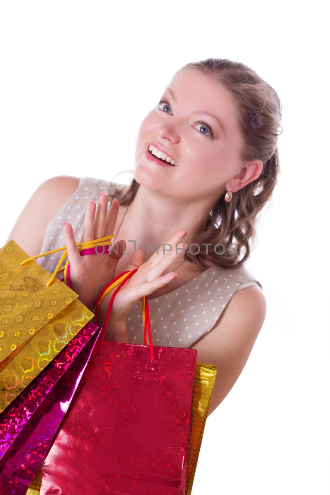 Amazed woman with shopping bags isolated on white