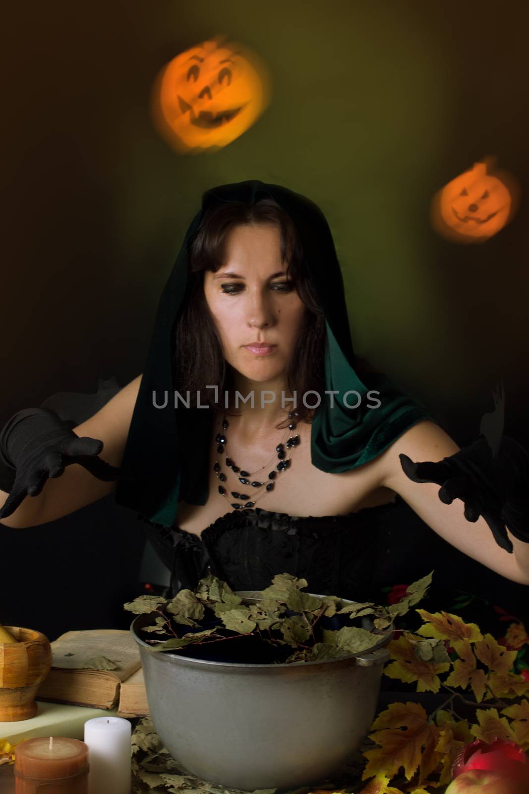 Witch practising sorcery at Halloween night