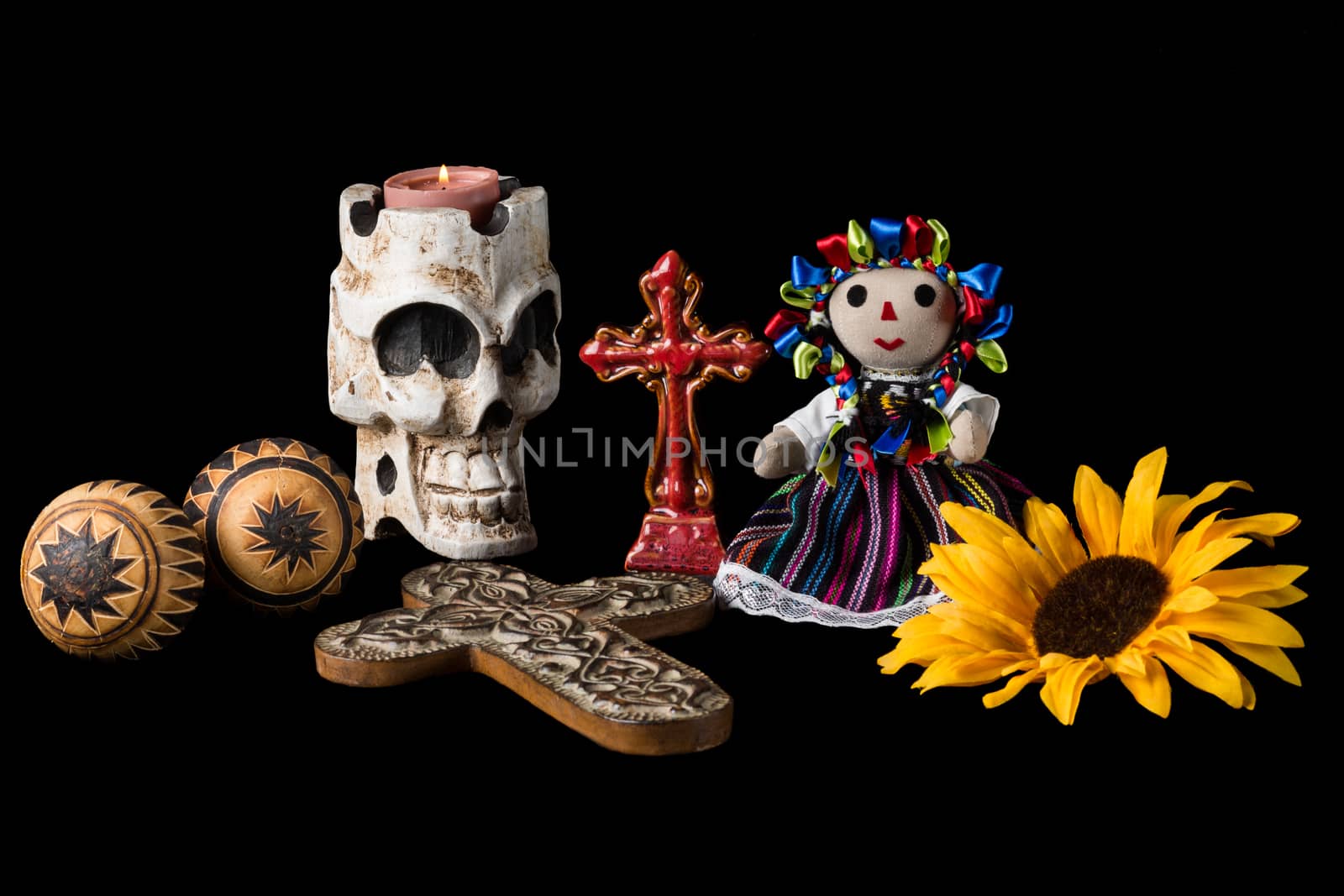 Traditional Day of the Dead (Dia de los muertos) Mexican alter with skull candle, cross, maracas, sunflower and Mexican doll.