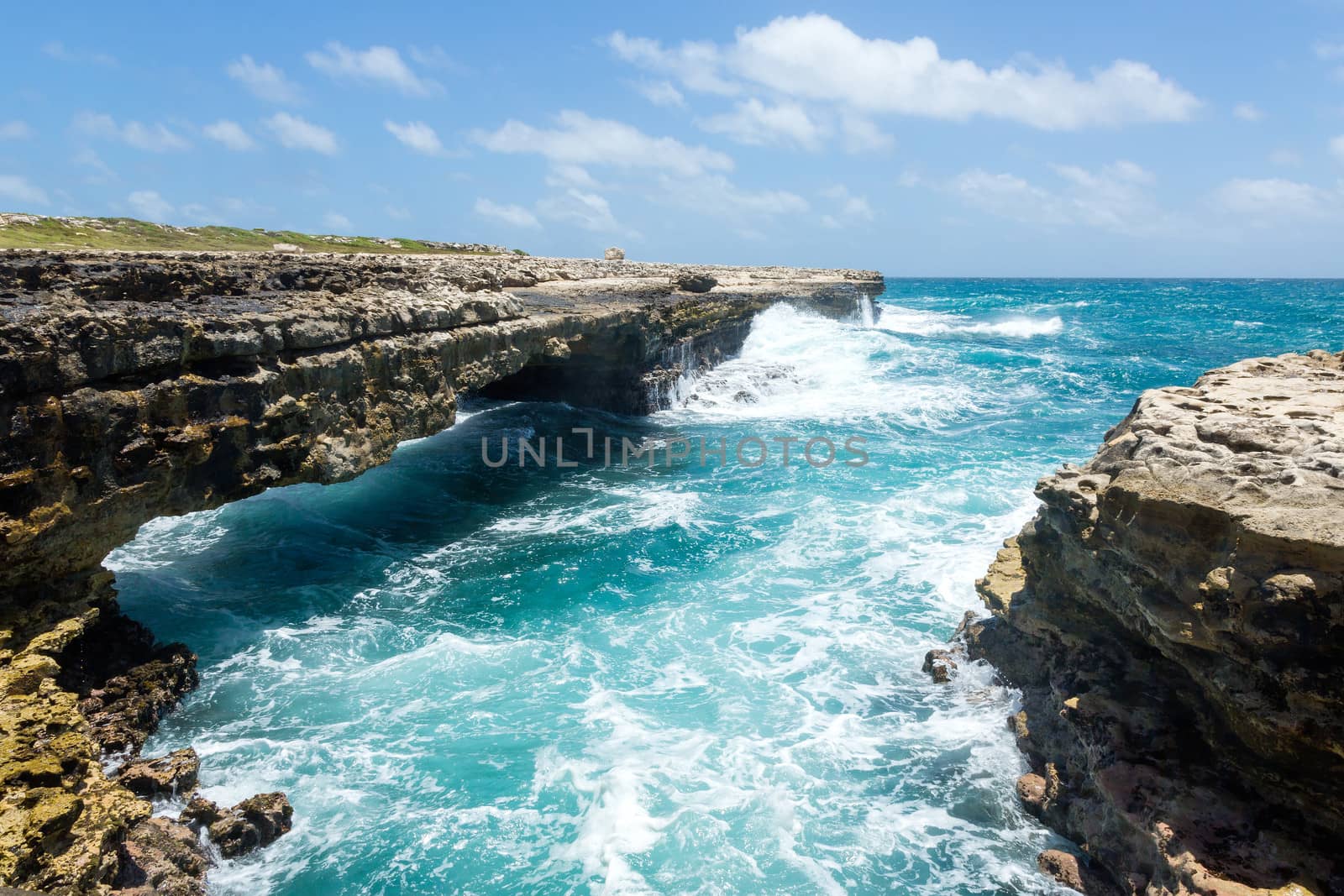Waves Crashing on Rocks at Devil's Bridge Antigua in Sunshine