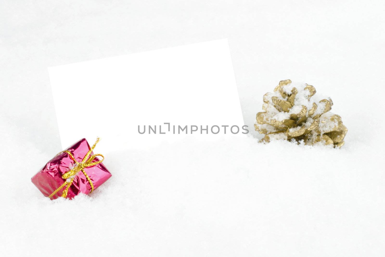 Blank white card with christmas decoration in the snow