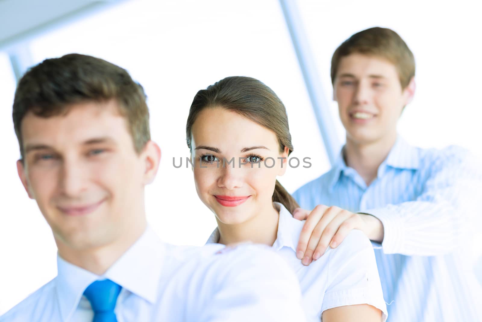 portrait of a young business woman standing in line with colleagues, concept of teamwork