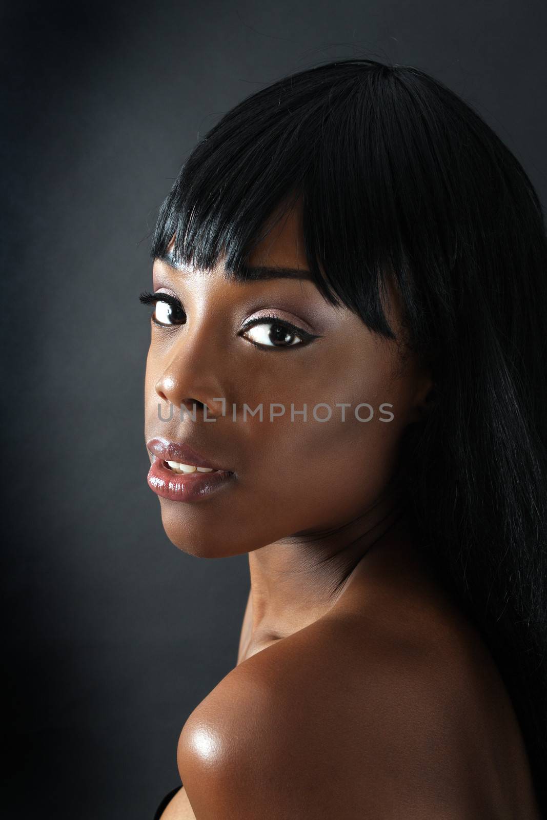 A close-up of an extraordinarily beautiful young black woman with amazingly captivating eyes.