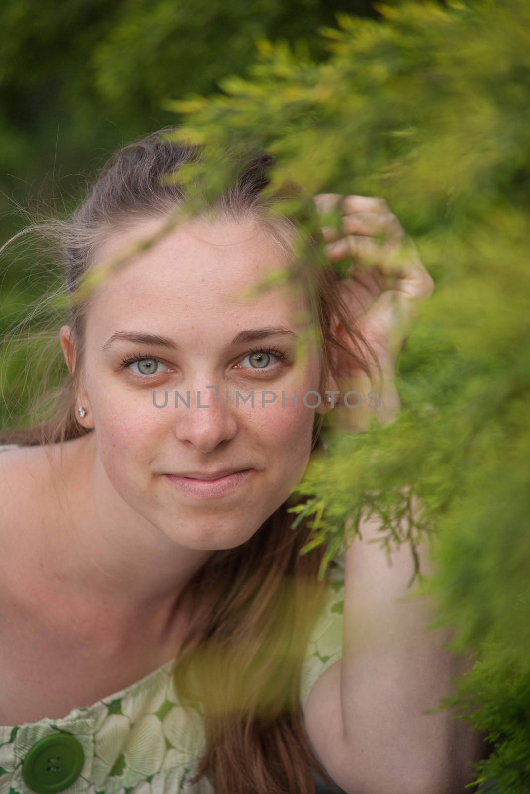 Beautiful young woman in park in summer