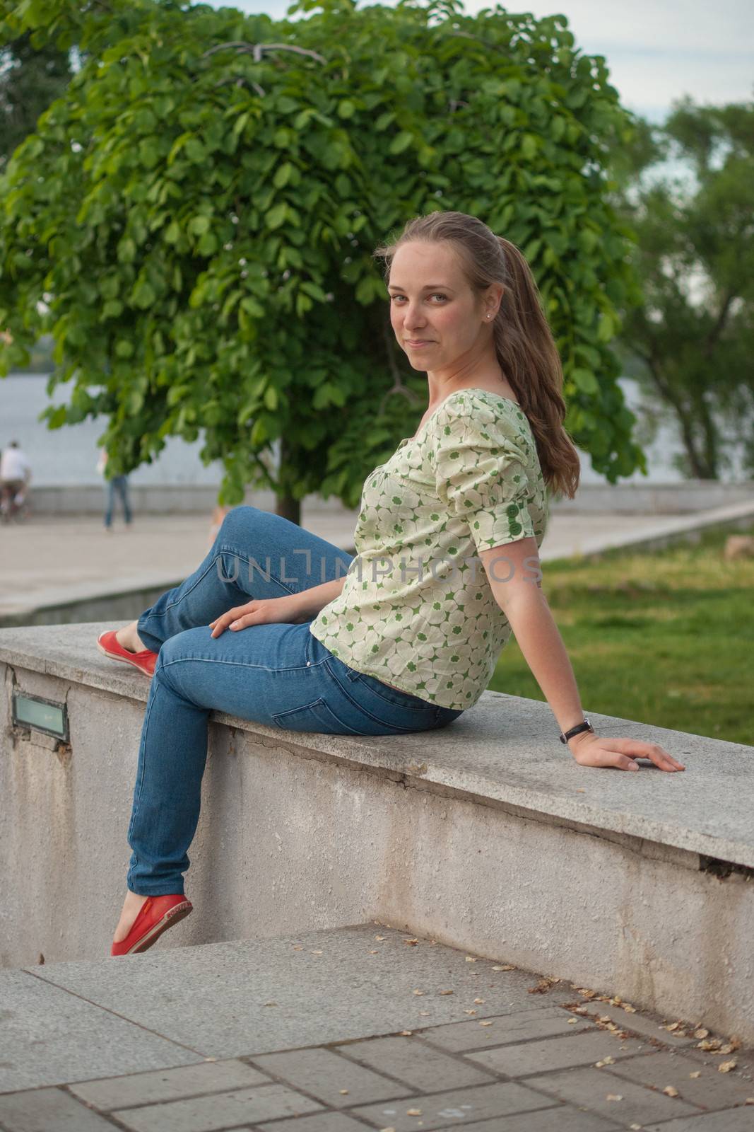 Beautiful young woman in park in summer