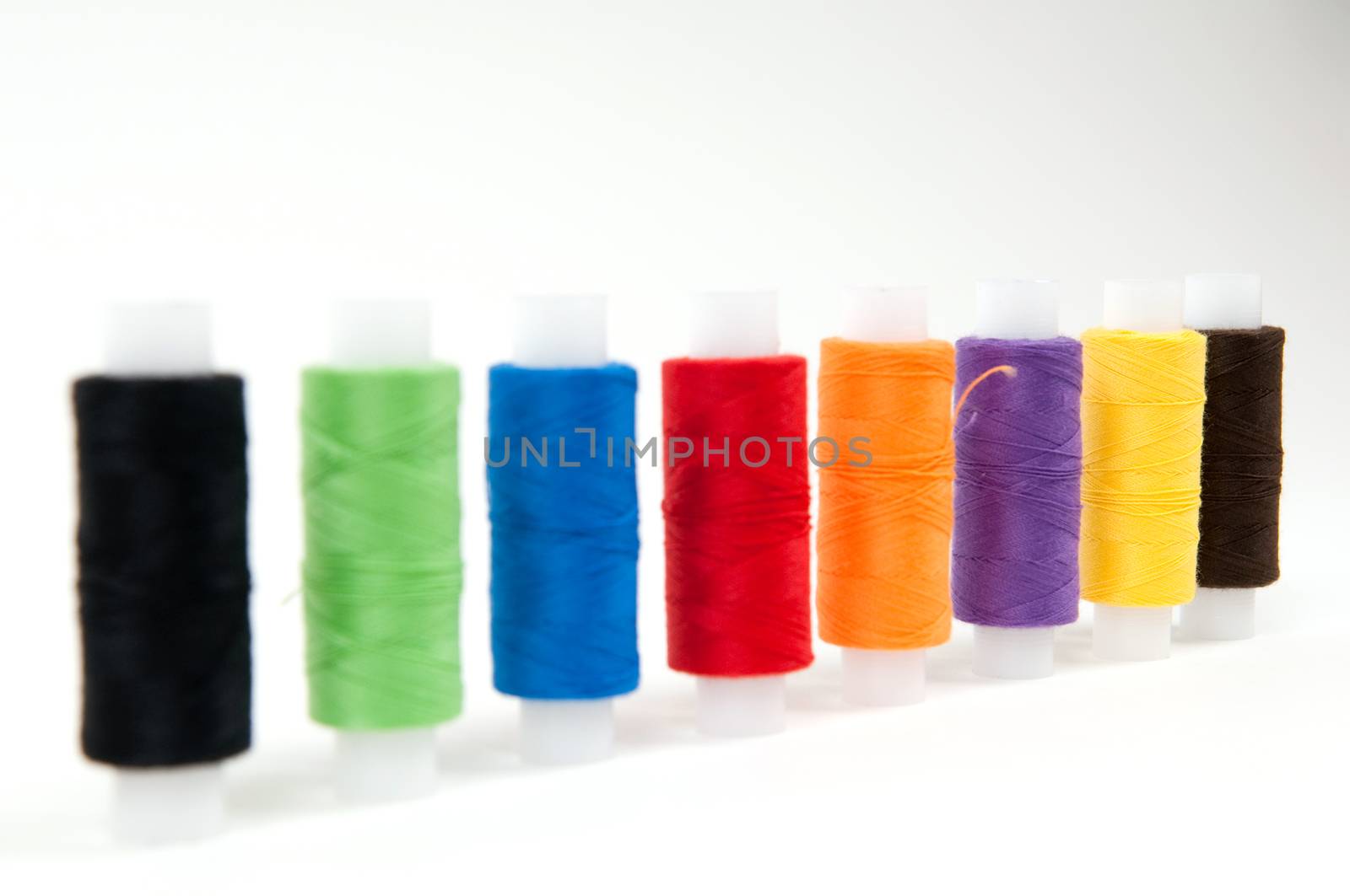 Set of sewing threads on white backgrounds by lexan