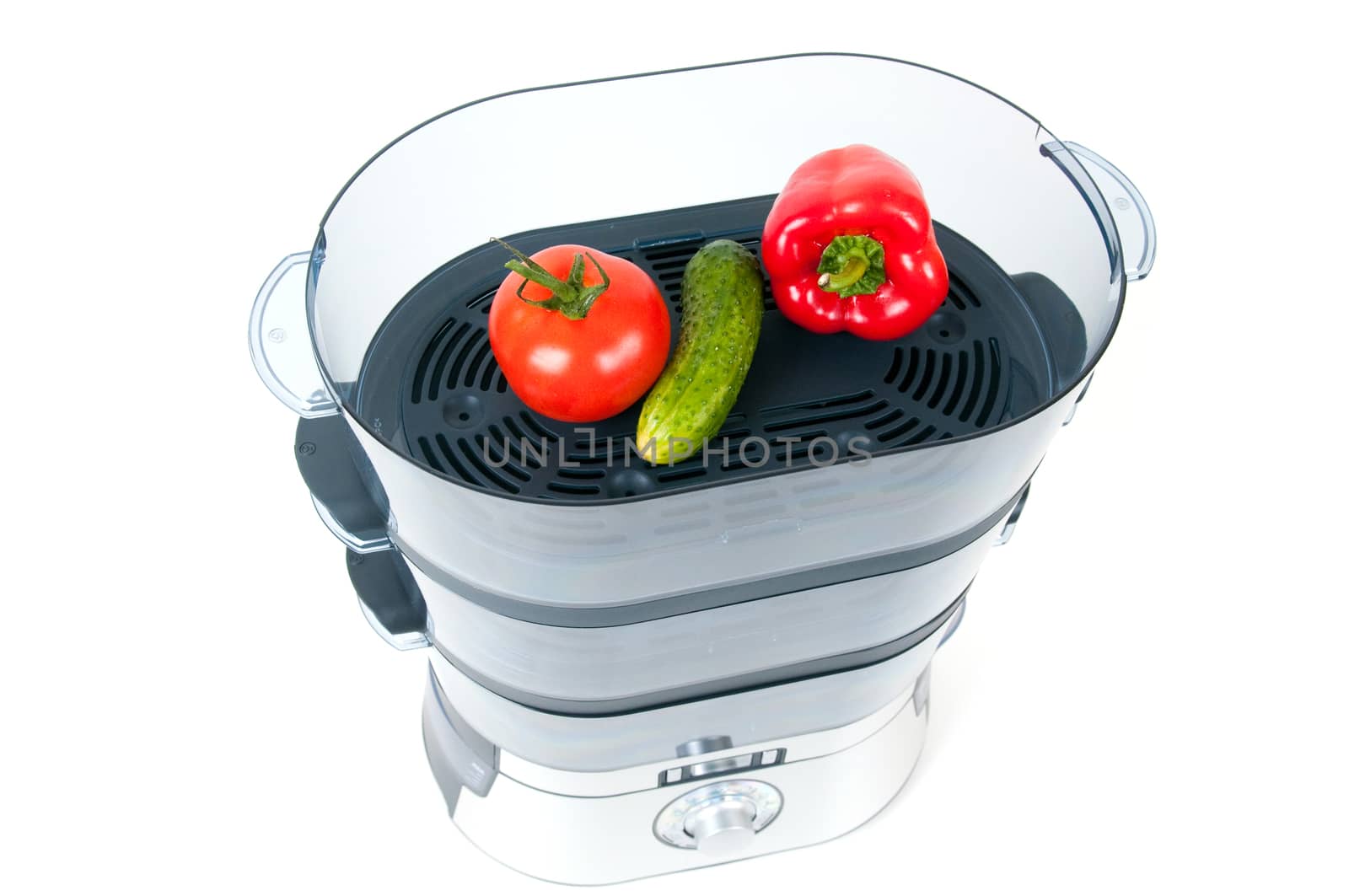 modern electric steamer with fresh vegetables on a white background 