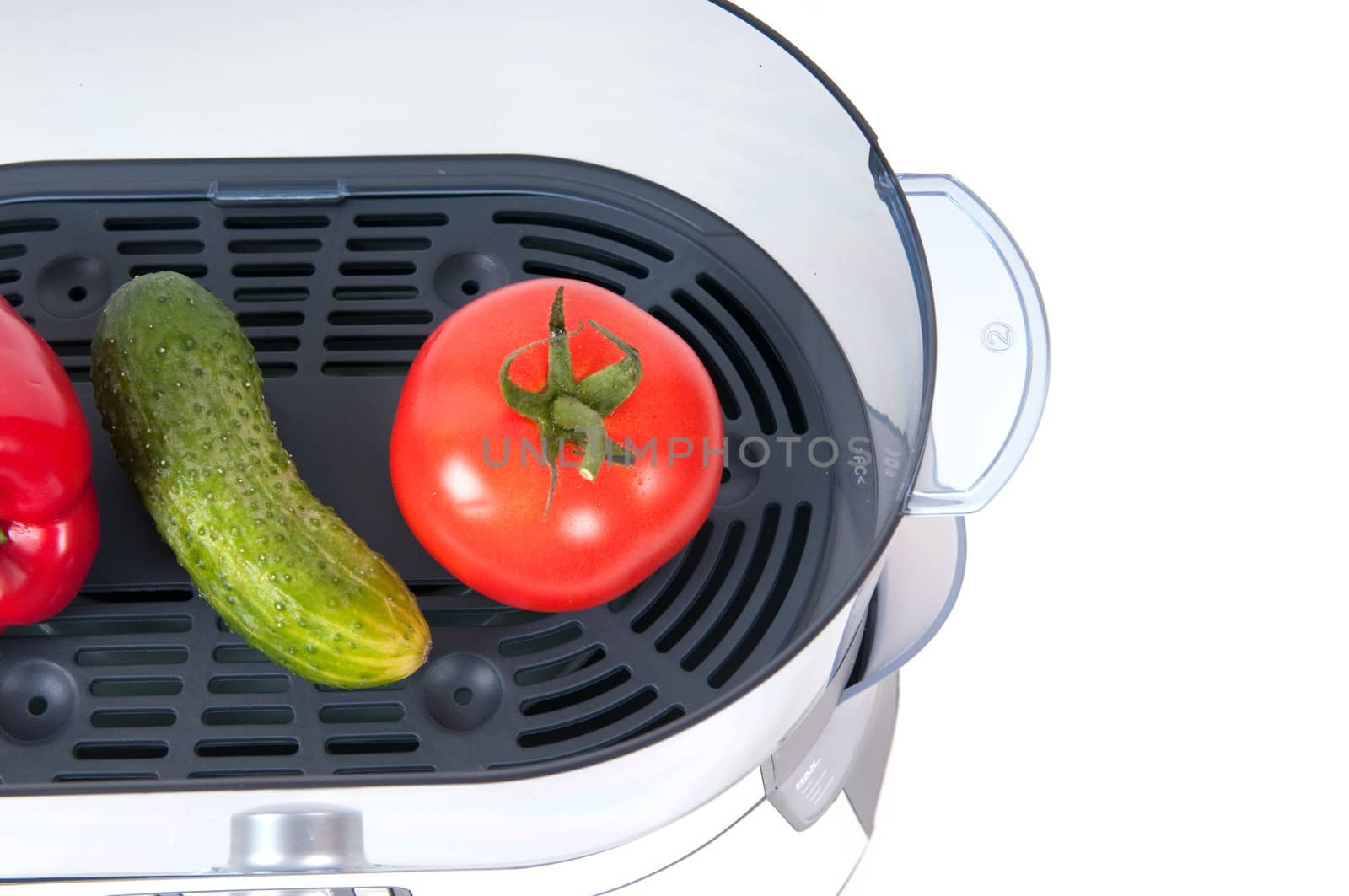 modern electric steamer with fresh cucumber and tomato on a white background