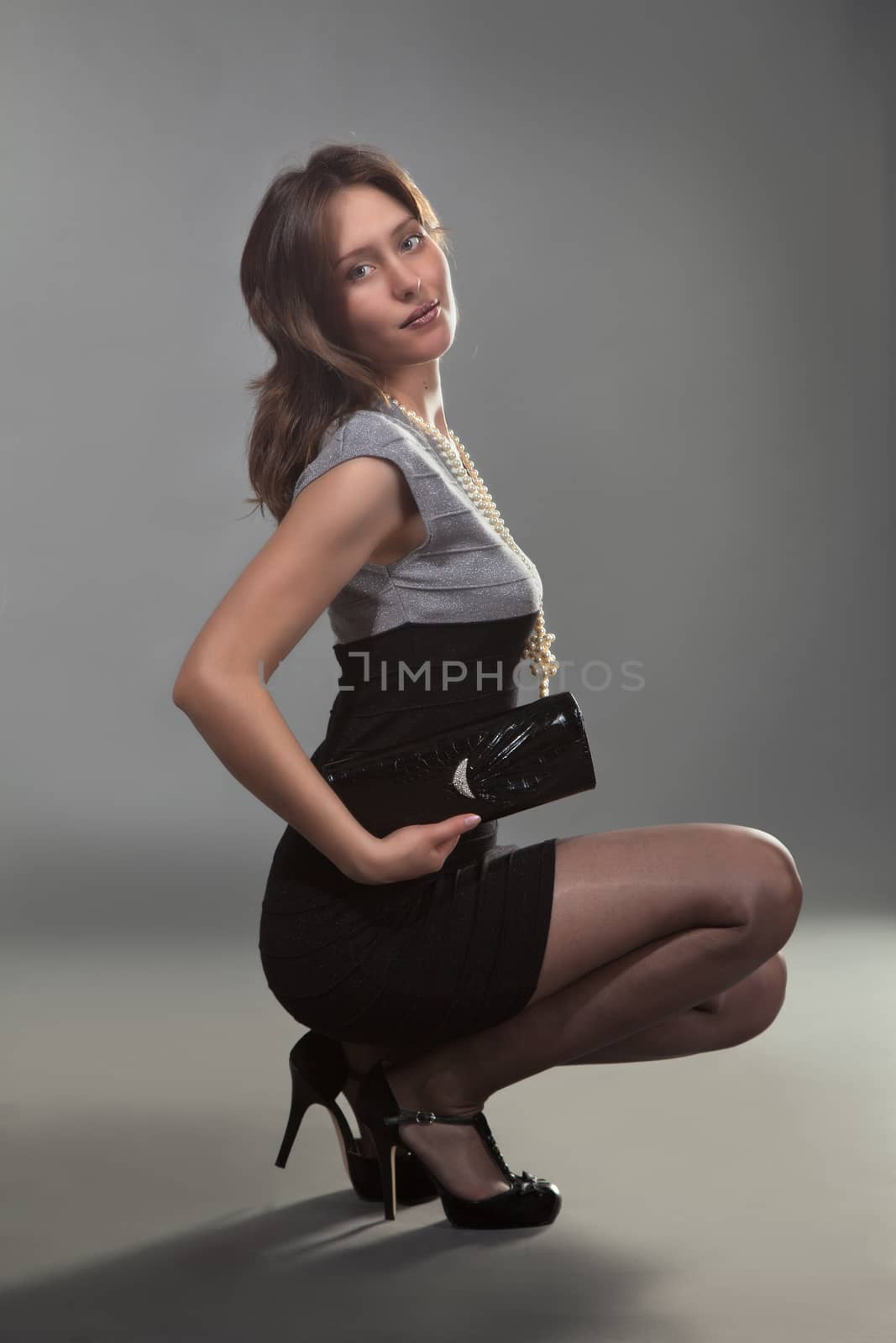 lovely young girl posing sitting in studio