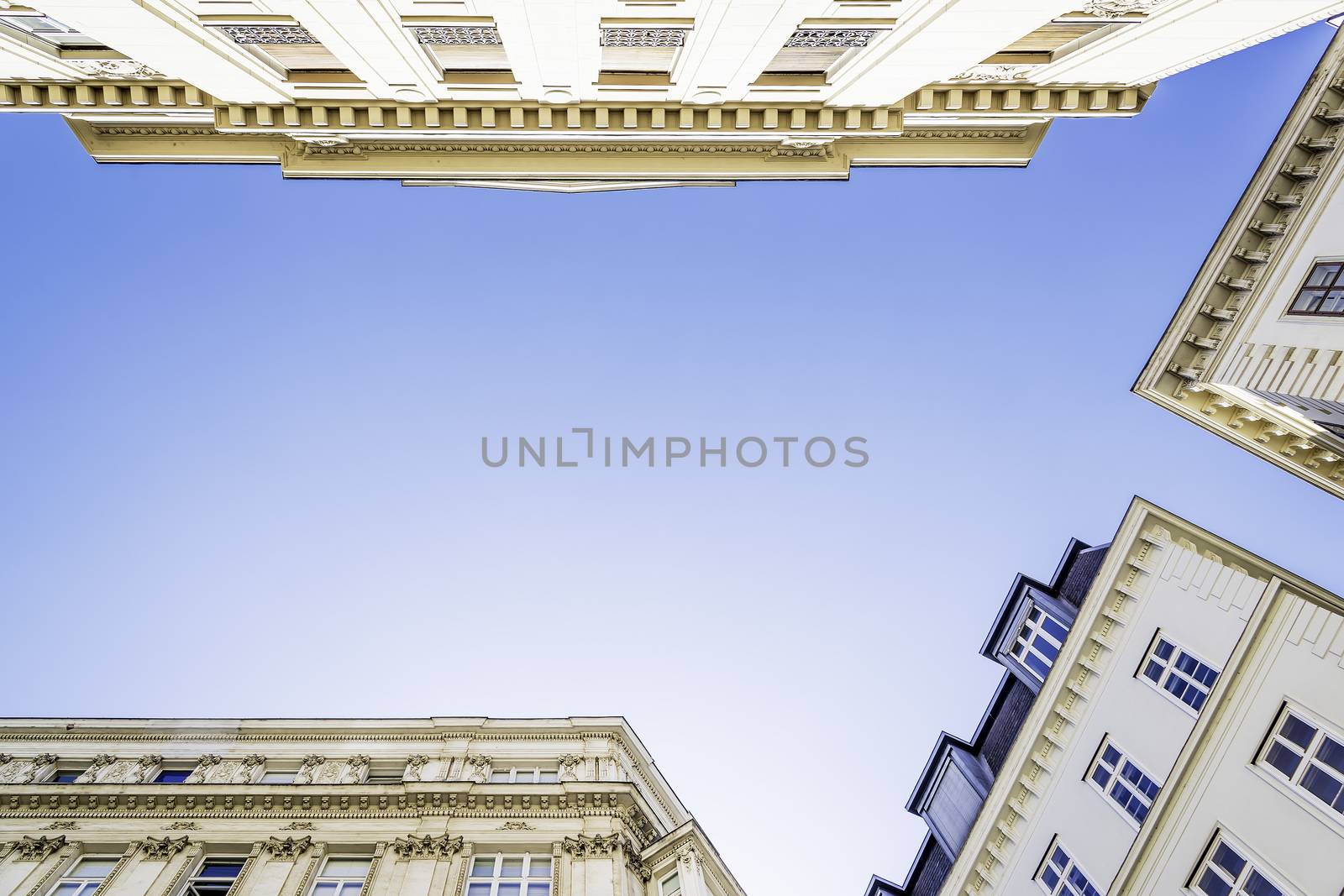 View from below of historic building in Vienna, Austria with blue sky for background