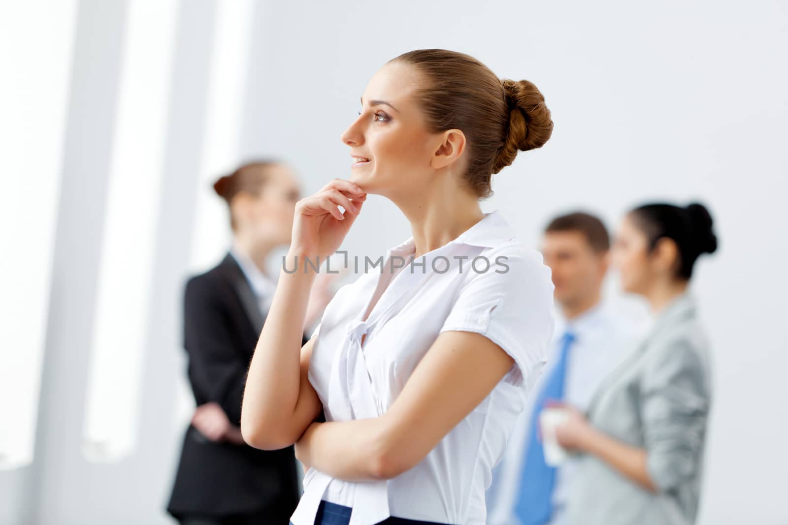 Image of four pretty young businesswomen standing in row