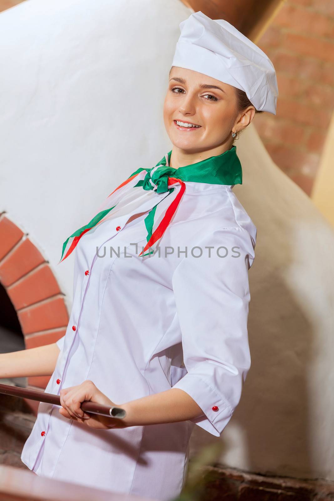 Image of young woman cook standing at kitchen