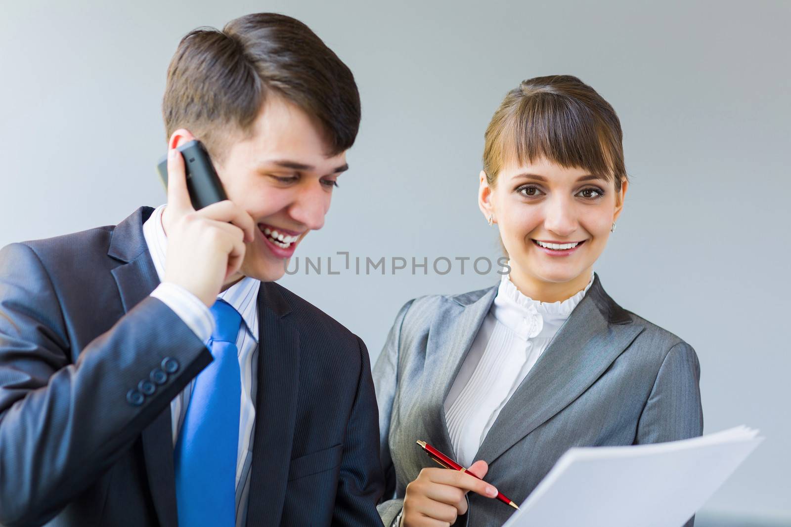 Young happy businessman and businesswoman people discussing project