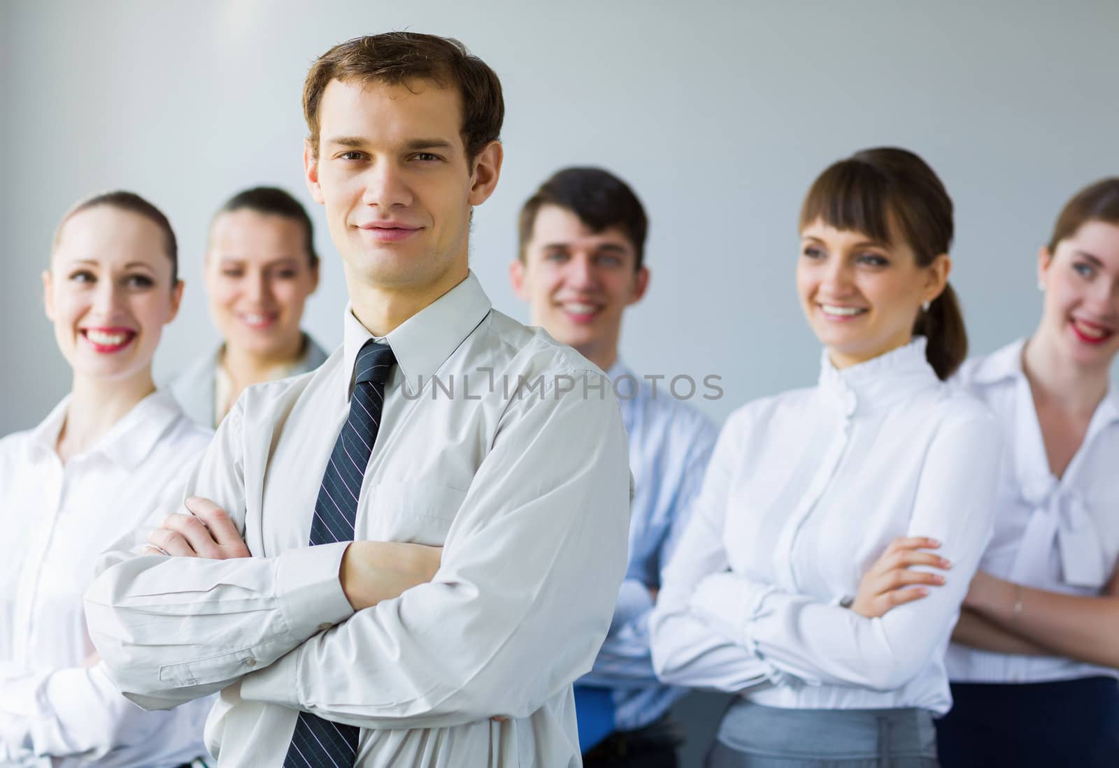 Young business people standing with arms crossed on chest