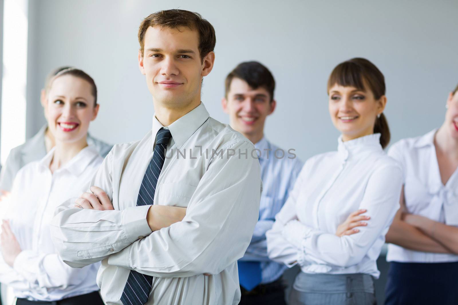 Young business people standing with arms crossed on chest