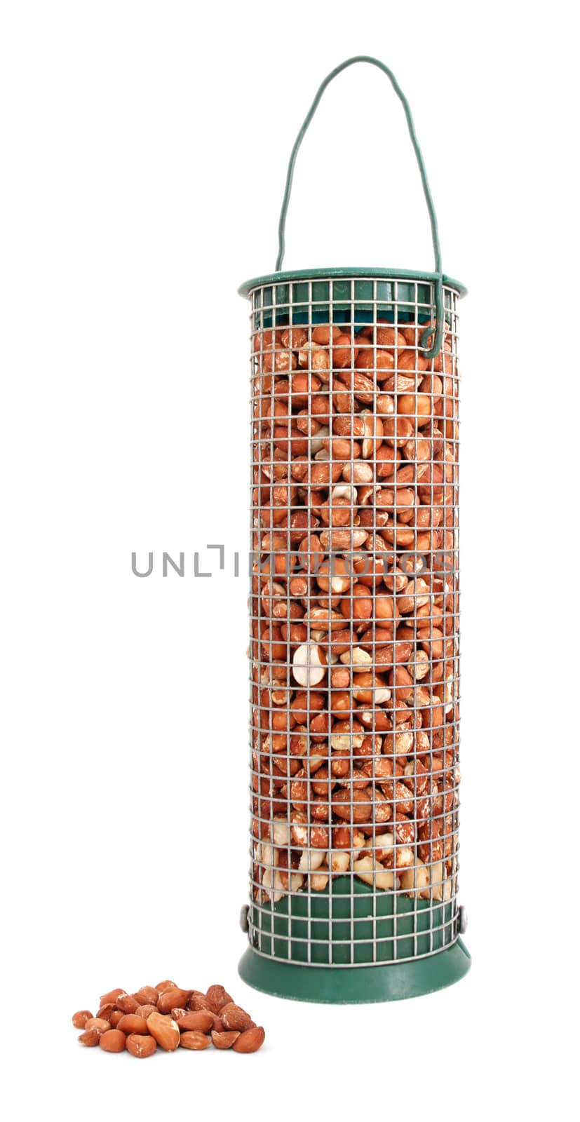 Bird feeder filled with peanuts and some nuts lying loose, isolated on a white background