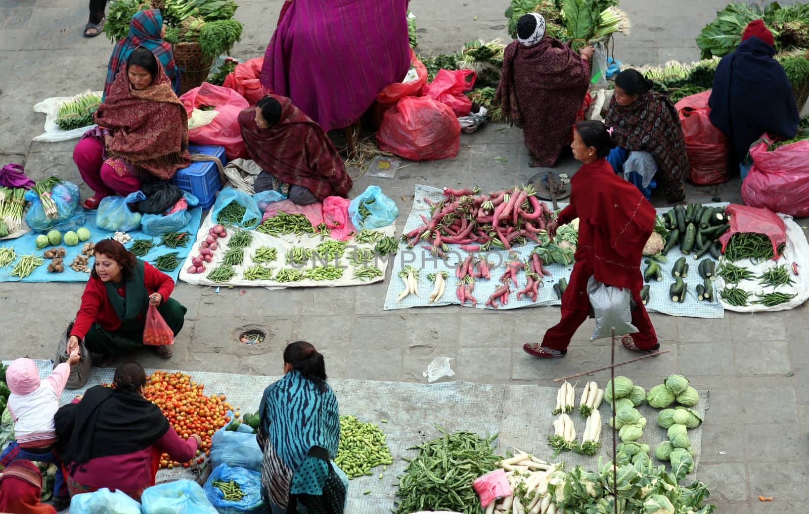 Pavement vegetable market on Darbar (Durbar) Square, Kathmandu, Nepal. December 27, 2012. The market serves small retailers of vegetable as a source of income.