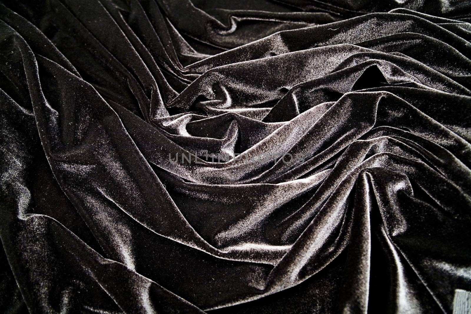 Black velvet material folds as background