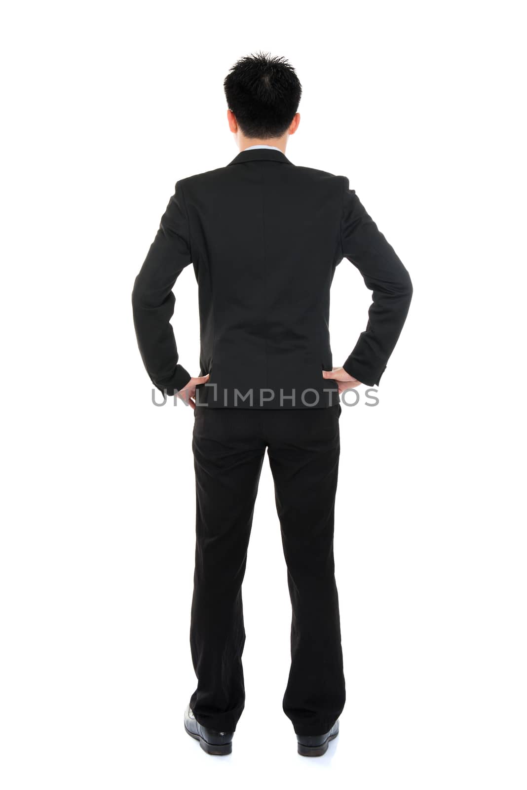 Rear or back view full body Asian business man in formal suit standing isolated on white background