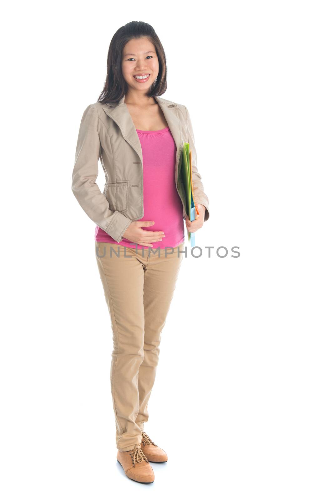 Full body six months pregnant Asian businesswoman holding file folder document standing isolated on white background.