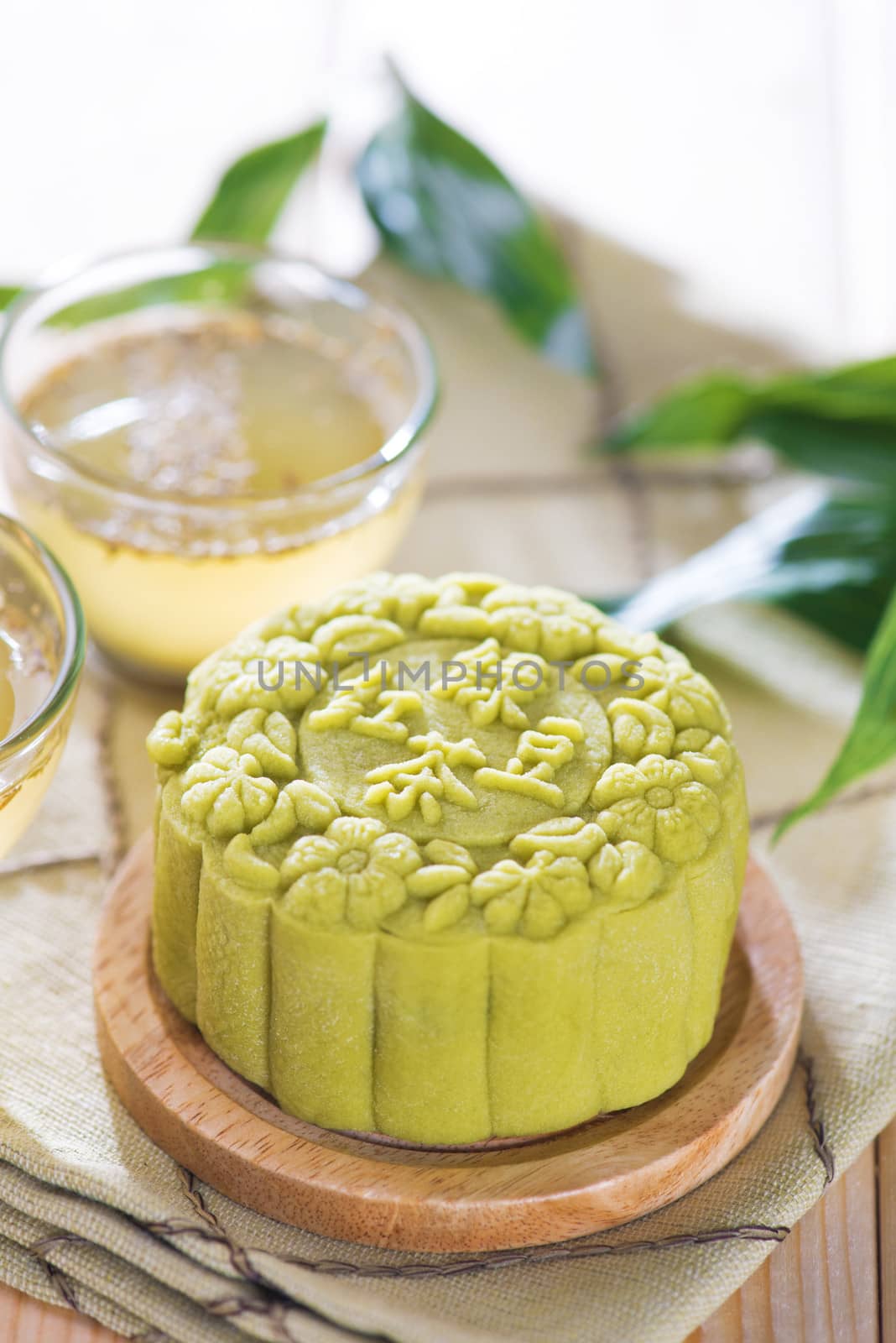Traditional Chinese mid autumn festival food. Snowy skin mooncakes.  The Chinese words on the mooncakes means green tea with red bean paste, not a logo or trademark.