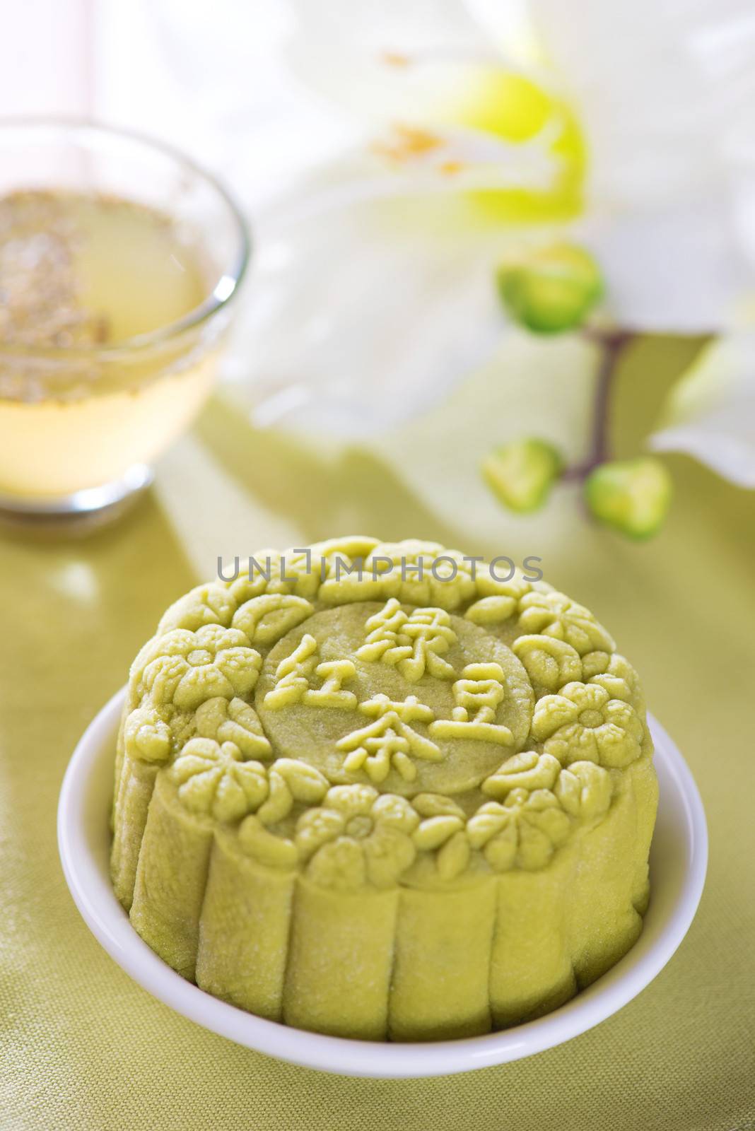 Snowy skin mooncakes.  Traditional Chinese mid autumn festival food. The Chinese words on the mooncakes means green tea with red bean paste, not a logo or trademark.