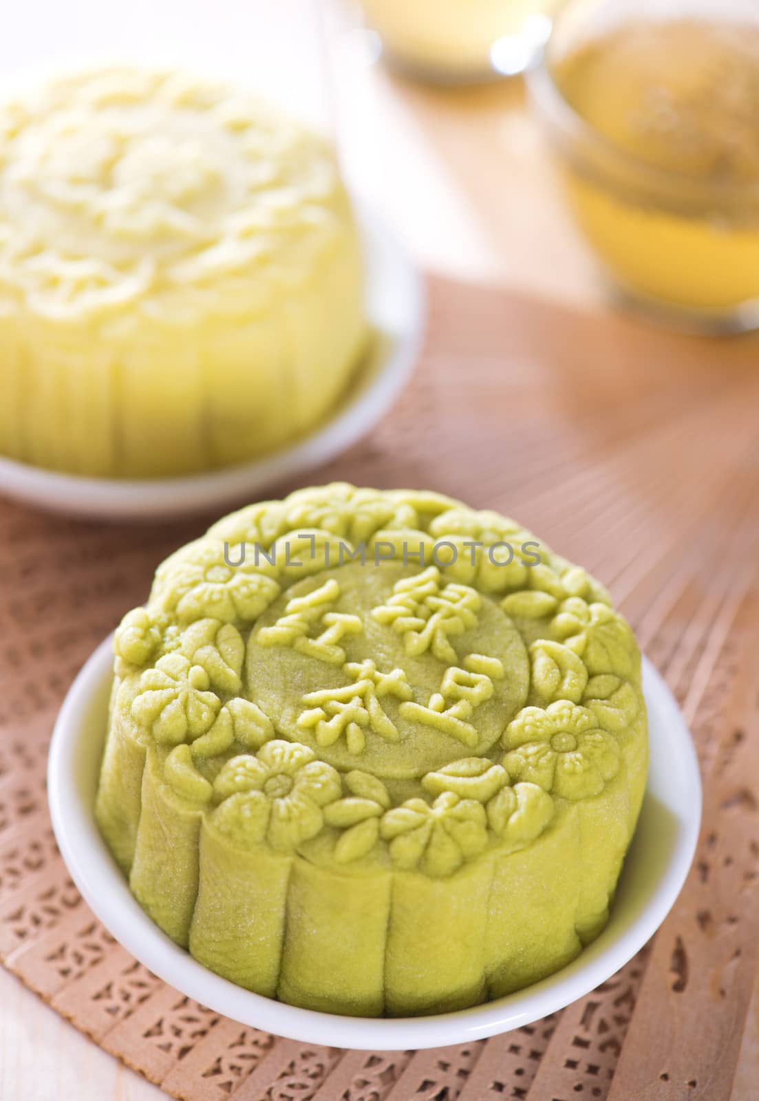 Snowy skin mooncakes.  Traditional Chinese mid autumn festival food. The Chinese words on the mooncakes means green tea with red bean paste and lotus paste, not a logo or trademark.